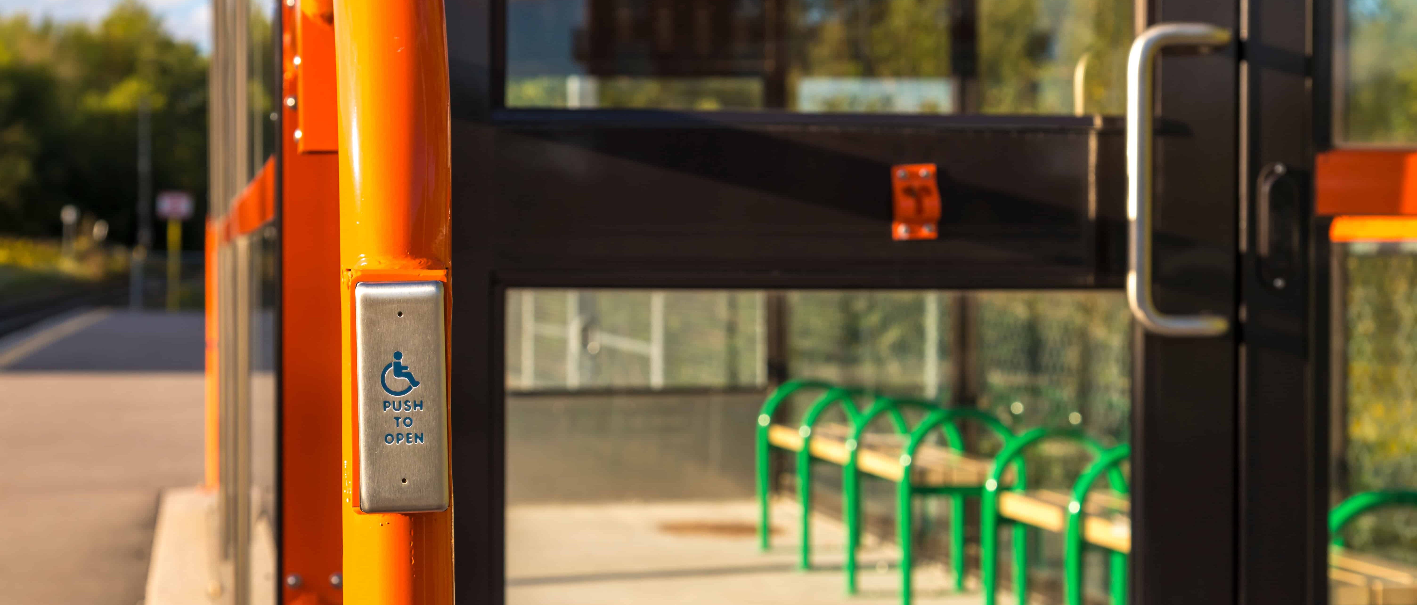 Orange ADA doors with wheelchair accessible push to open button
