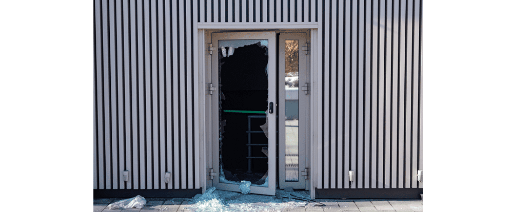Storefront door damage due to a break-in at an industrial building.